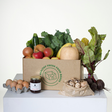 Load image into Gallery viewer, The Gluten-Free Box pictured is packed with organic fruits and vegetables like apples, beetroot, pumpkin, bananas, zuchini, onions, and more. There is also a bag of mushrooms, half a dozen eggs, and a jar of quice jelly as the Grocery Surprise.