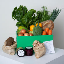Load image into Gallery viewer, Healthy Fresh Food Boxes also caters to vegans with the Vegan Box. The Vegan Box does not contain eggs, and the Grocery Surprise is specially picked to exclude animal products. The Vegan Box shown is packed with leafy greens and other staples like carrots, broccoli, onions, mushroooms and potatos. There is also a loaf of freshly baked bread from Ovens Street Bakery, and a jar of pickles from Gorgeous George as the Grocery Surprise.